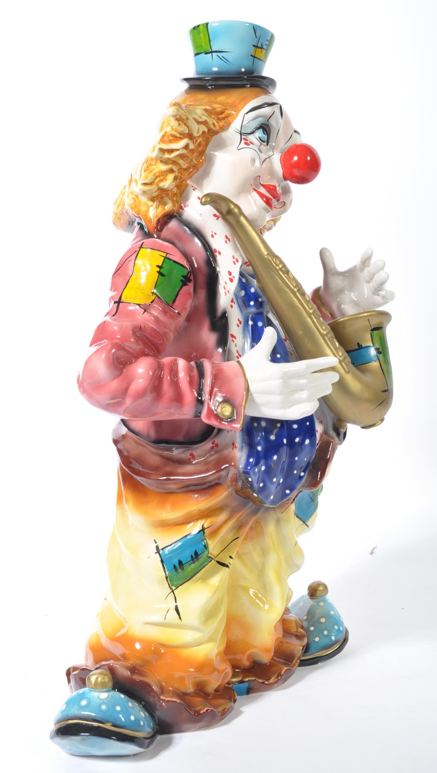 A fantastic 20th century ceramic floor standing clown, finished with an ...