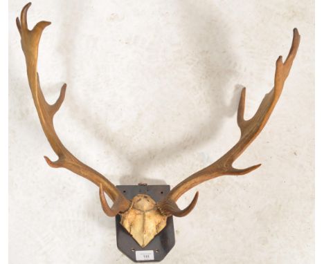 A pair of early 20th century mounted vintage Stag / deer nine point antlers mounted on an oak armorial shield mount.&nbsp;Mea