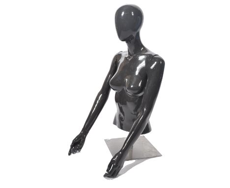 A good quality contemporary shop haberdashery tailors dummy - mannequin being raised on polished steel plinth adjustable base