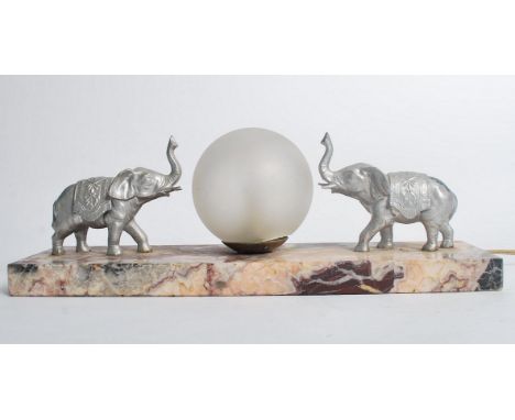 A 1930's Art Deco rouge marble and elephant table lamp. The silvered elepants flanking a frosted spherical globe all raised o