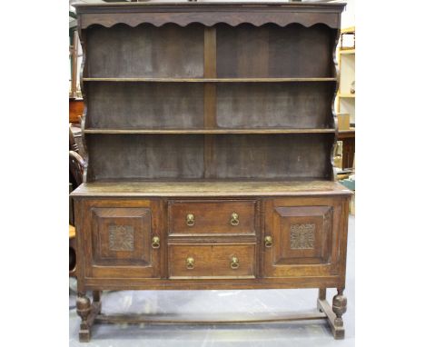 A Victorian oak dresser, the shelf back above two drawers flanked by cupboards, height 206cm, width 171cm, depth 55cm.Buyer’s
