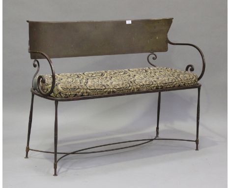 An early 20th century wrought steel bench with carved panel back, height 82cm, width 111cm, depth 52cm.Buyer’s Premium 29.4% 