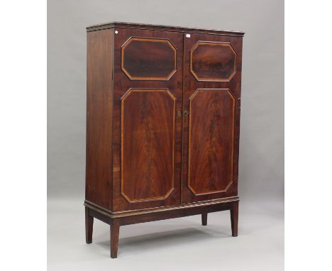 A 19th century figured mahogany cabinet, crossbanded in satinwood and enclosed by two doors, with later stand, on square tape