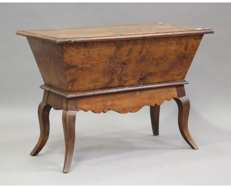 A 19th century Continental elm and fruitwood dough bin, the removable lid above shaped legs, height 70cm, width 100cm, depth 