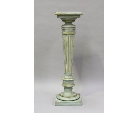 A 20th century green and gilt painted display pedestal with a fluted stem, height 111cm, width 33cm.Buyer’s Premium 29.4% (in