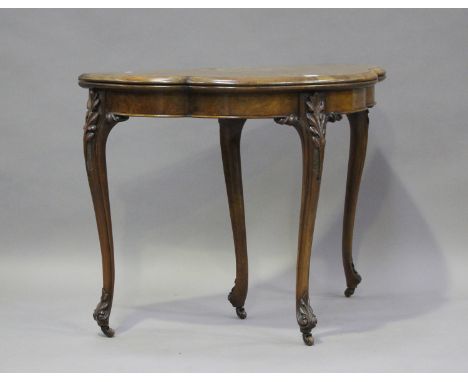 A mid-Victorian walnut fold-over card table with foliate inlaid decoration, on carved cabriole legs, height 75cm, width 95cm,