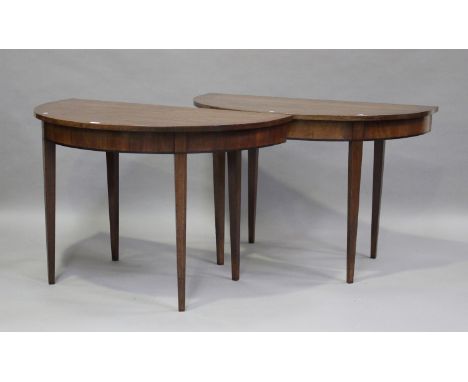 A pair of 19th century mahogany 'D'-end console tables, raised on square tapering legs, height 73cm, width 113cm, depth 62cm.