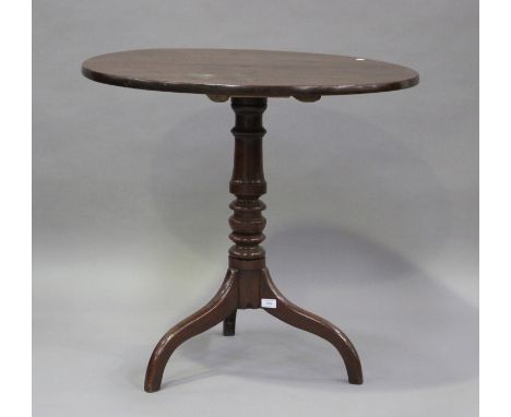 A 19th century mahogany tip-top wine table, raised on a turned column and tripod legs, height 77cm, diameter 82cm.Buyer’s Pre