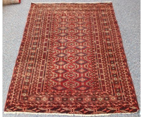 A Turkoman style rug, 20th century, the claret field with two columns of guls, within a sunburst gul border, 149cm x 117cm, t