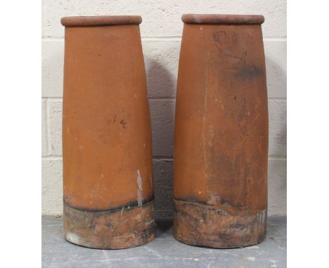A pair of terracotta chimneys, height 77cm, diameter 30cm.Buyer’s Premium 29.4% (including VAT @ 20%) of the hammer price. Lo