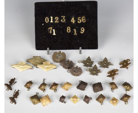 A large collection of early 20th century military cap badges and insignia, mainly New Zealand and Canadian, including 78th Wi