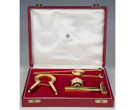An Asprey gilt metal bar tool set, boxed, width 23cm.Buyer’s Premium 29.4% (including VAT @ 20%) of the hammer price. Lots pu