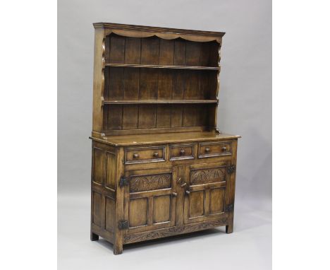 A 20th century Jacobean style oak dresser, the shelf back above three drawers and a cupboard, height 189cm, width 127cm, dept