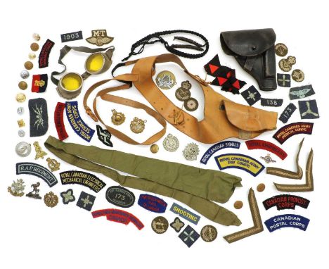 A group of military badges and shoulder titles,to include Royal Canadian Army Pay Corps, Canadian Provost Corps, and Royal Ca
