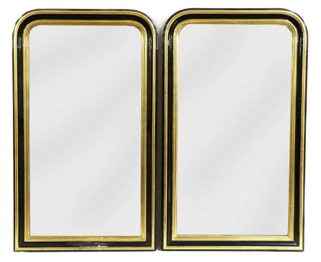 A pair of gilt and ebonised wall mirrors, late 19th century, with rounded tops, rectangular plates, 74cm wide 26cm high (2)Co