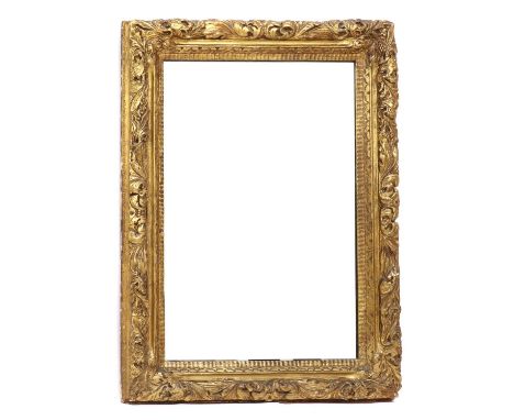 A Baroque-style gilt composition mirror, 19th century and later, the frame carved with fruit, flowers and foliage, enclosing 