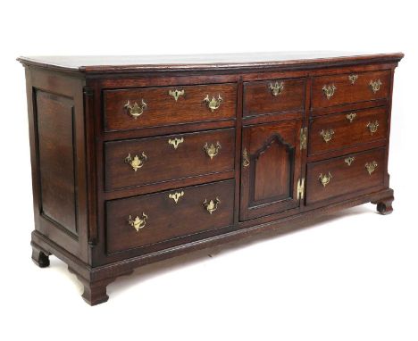 A George III oak dresser base,crossbanded in mahogany and with canted column sideson ogee bracket feet198cm wide59cm deep95cm