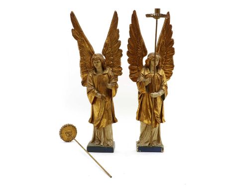 A pair of carved polychrome angels,late 19th century, each supporting a candlestick,46cm highCondition ReportChips, losses an