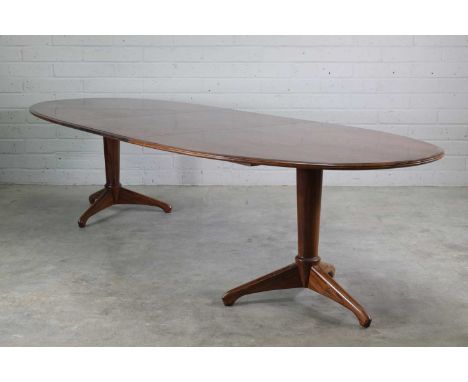 § A rosewood dining table,1960s, designed by A J Milne, the elliptical top with a moulded edge, with an extra leaf, raised on