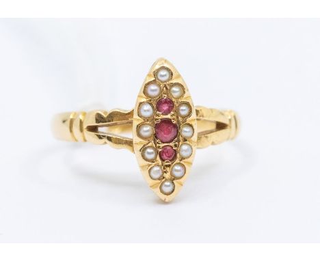 An early 20th Century ruby and pearl set 18ct gold dress ring, marquise shaped setting, set to the centre with three graduate