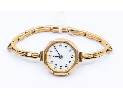  A 9ct gold ladies wristwatch, white enamel dial number markers, on a plated expandable strap, total gross weight approx  16.