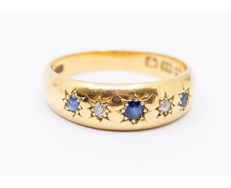 A Victorian sapphire and diamond 18ct gold ring, comprising three round cut sapphires with two old cut diamond accents, star 