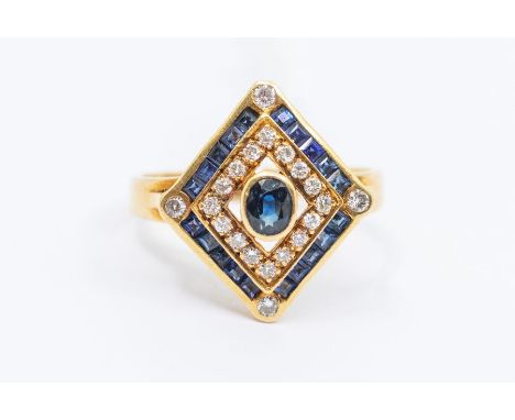 A sapphire and diamond 18ct gold ring, comprising a diamond shape set to the centre with an oval rub over set sapphire, withi