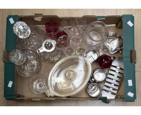 A collection of glass wares including decanters, ruby glass, silver topped decanter, claret jug with white metal top, etched 