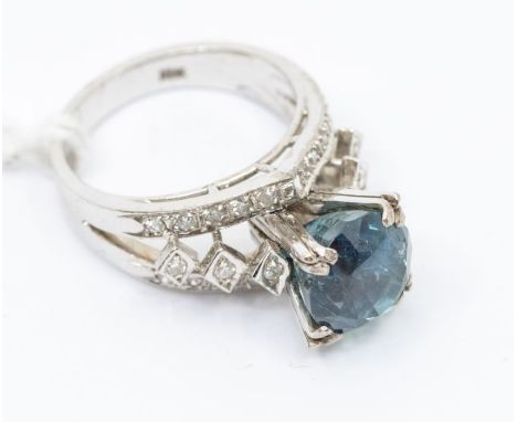 A sapphire and diamond and white metal cluster ring, high claw setting with a deep round cut sapphire to the centre, approx 9