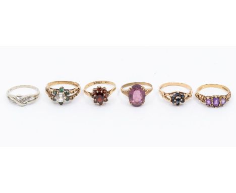 A collection of six 9ct gold gem set rings, to include a white gold diamond cross over ring, size O, garnet set cluster, size