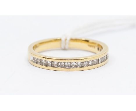 A diamond and 18ct yellow gold half set eternity ring by Iliana, comprising twenty princess cut diamond channel set to the fr