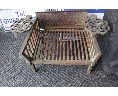 A 19th Century cast iron fire grate, moulded detail on fireback, with hinged trivets