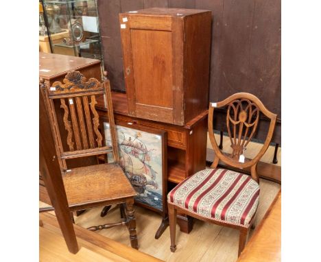 A collection of furniture, comprising a mahogany bookshelf, a small firescreen with a woolwork scene, a mahogany side cupboar