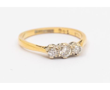 An 18ct gold three stone diamond ring, total diamond weight approx 0.30ct, platinum mount to a 18ct gold shank, size N, total