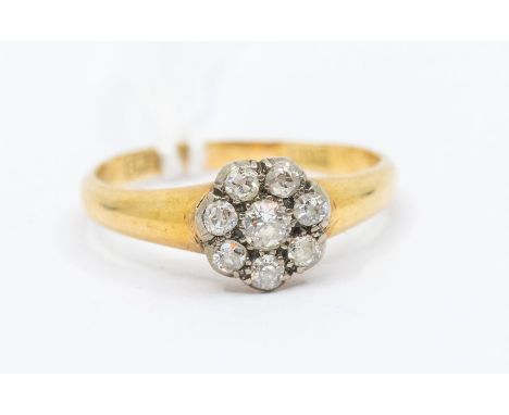 An early 20th century diamond and 18ct gold flower head cluster ring, set with old cut diamonds with a total diamond weight a