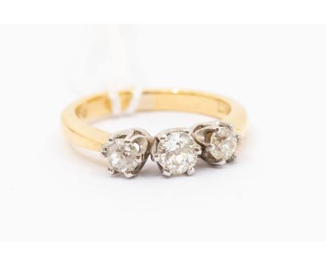 A three stone diamond and 18ct gold ring, comprising three old cut diamonds with a total diamond weight approx. 0.70ct, claw 