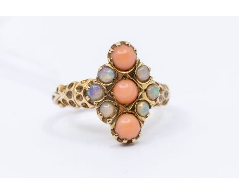 A Victorian opal and coral 9ct gold cluster ring, with a vertical row of cabochon cut coral with round cut opal accents set t