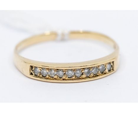A yellow metal diamond set half eternity ring, probably 14ct gold, set with 10 individually set faced diamonds, ring size R 1