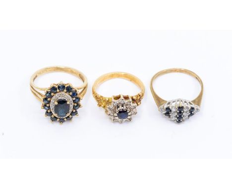 A collection gold sapphire set cluster rings, comprising an 18ct gold sapphire and diamond flower head cluster ring, size I1/