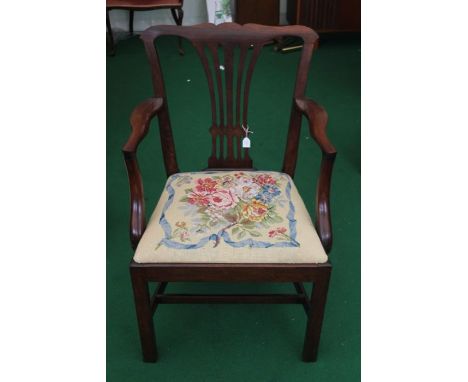 A George III mahogany open armchair, circa 1770, in the manner of Thomas Chippendale, with a pierced back splat, woolwork sea