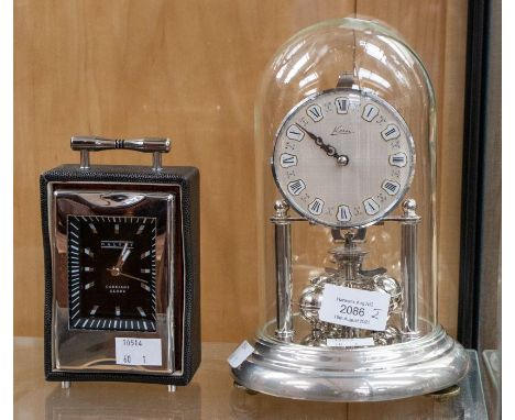 A modern German anniversary clock, with glass dome together with a Dalvey carriage clock and case (2)