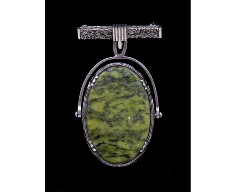 A Scottish silver hardstone swivel brooch, comprising a decorative lapel bar brooch suspending an oval green hardstone swivel