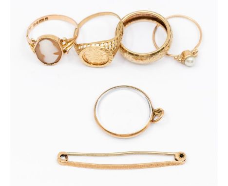 A collection of 9ct gold rings including a cameo set ring, size N, along with a textured band and coin ring, along with a 9ct