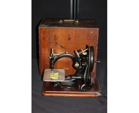 Willcox &amp; Gibbs "Automatic" silent sewing machine, the ebonised body with remains if gilt decoration, on a mahogany plint