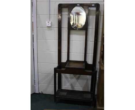 Edwardian hall stand, with central oval mirror flanking six hooks, the base with central hinged compartment flanked by two um