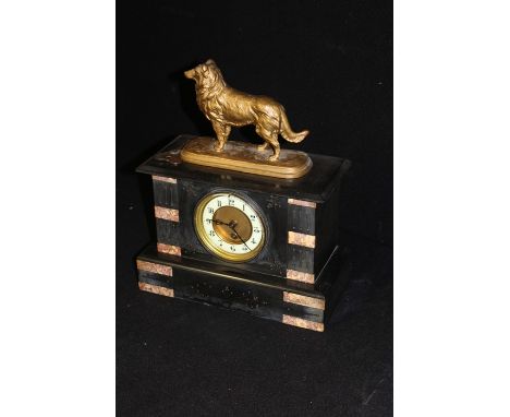 Victorian black slat mantel clock, with an enamel dial and single train movement, together with a model of a dog surmounted t