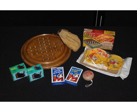 Circular wooden solitaire board and marbles, Kelloggs frosties water baffler puzzles and playing cards etc. (qty)