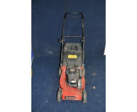 A CHAMPION PETROL LAWN MOWER with grass box (engine pulls freely but hasn't been started)