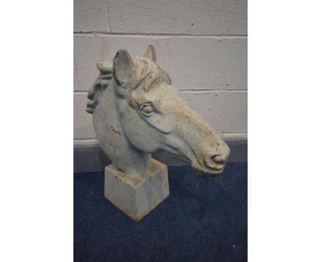 A CAST IRON HORSE HEAD, on a square tapered plinth