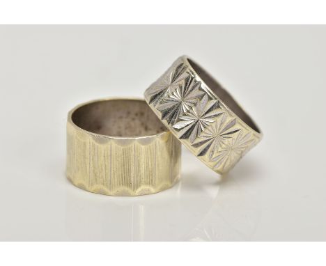 TWO 1960'S 9CT GOLD BAND RINGS, the first with engraved vertical banded design, the second with repeated diamond cut star des